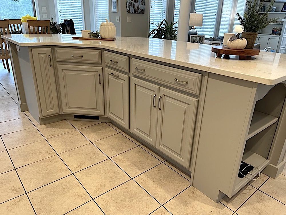 Kitchen cabinets painted to coordinate with floors and counter tops in Lancaster County by the professional cabinet painters at Martzall's Custom Surfaces.