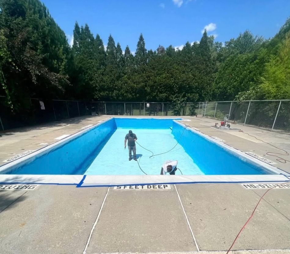 A man is standing in the middle of a swimming pool