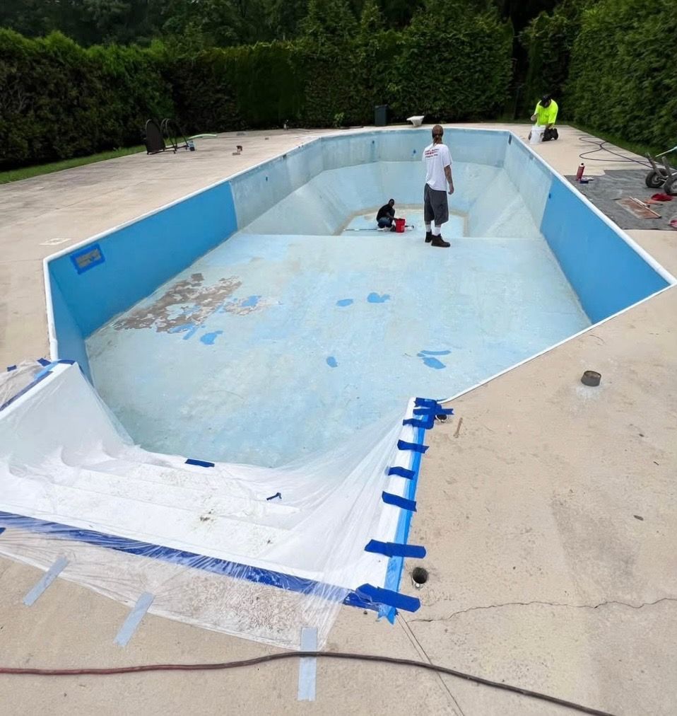 A man is standing in the middle of an empty swimming pool