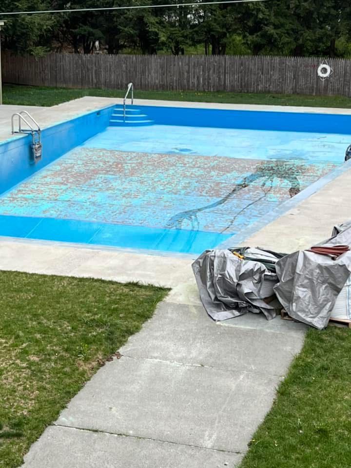 A swimming pool is being remodeled in a backyard.
