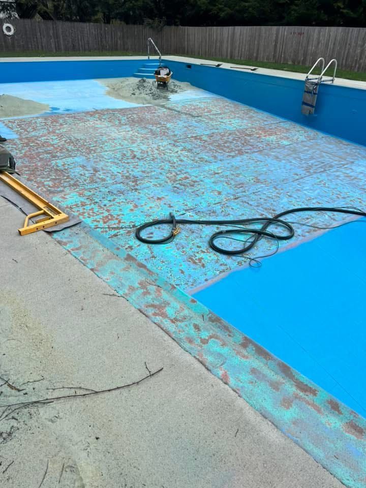 A swimming pool that is being painted blue