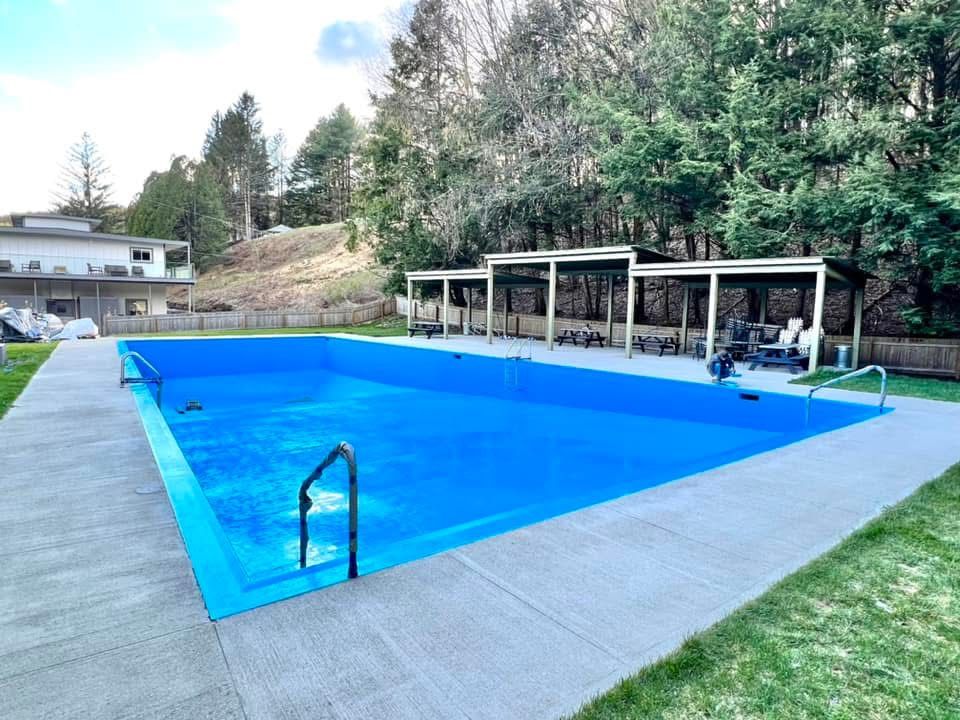 A large blue swimming pool with stairs leading to it