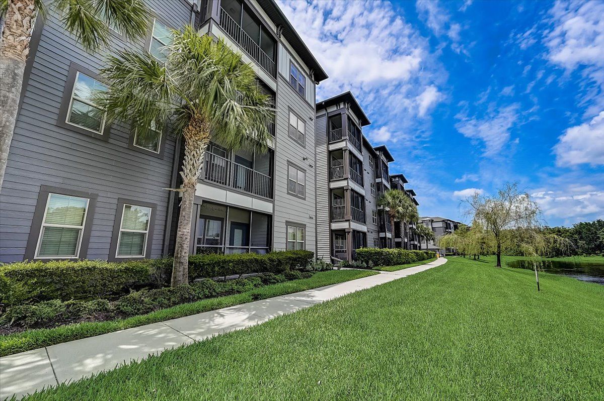 Creekside Ranch Apartments building and pathway surrounded by landscaped grounds