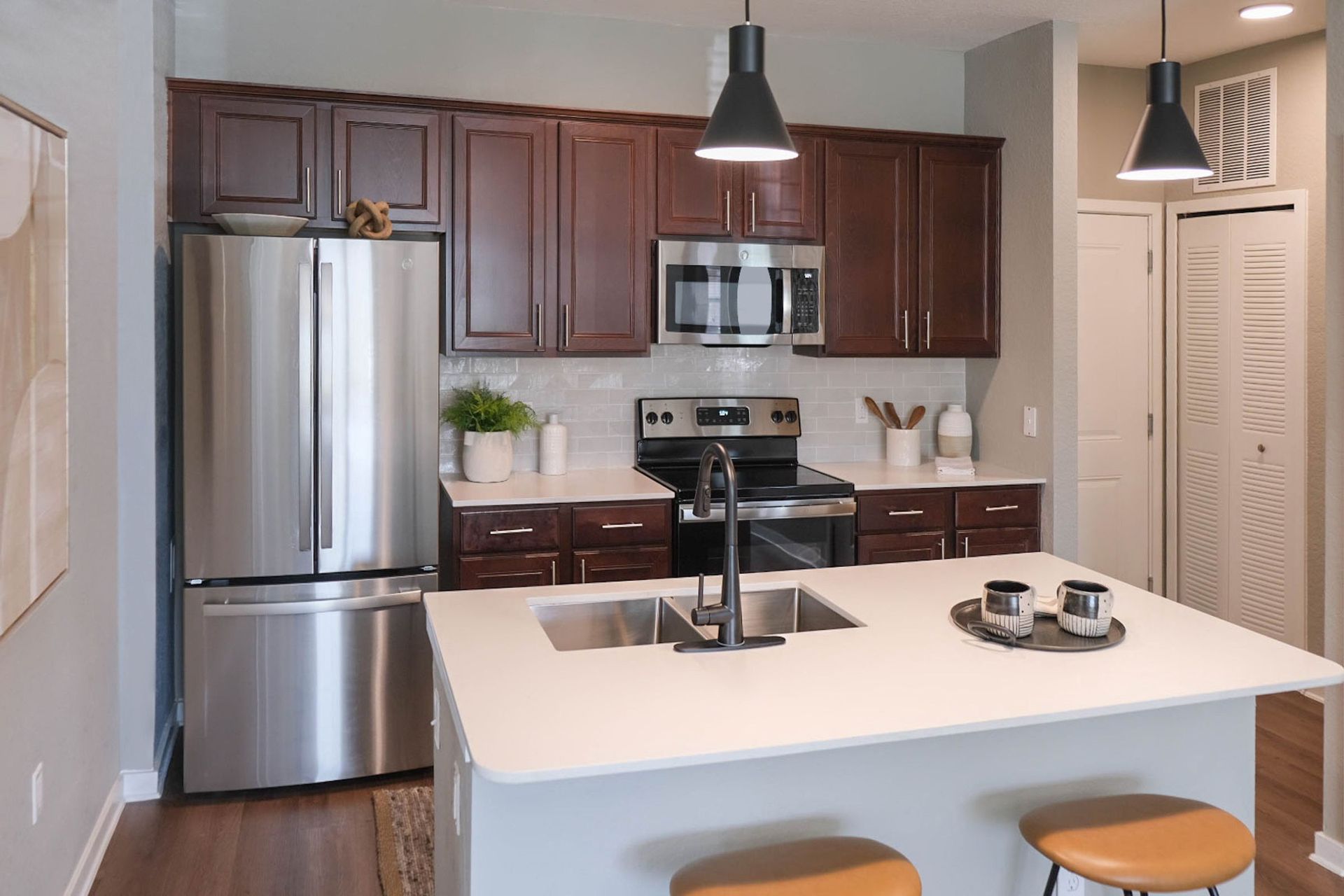 renovated kitchen with espresso cabinetry and stainless steel appliances