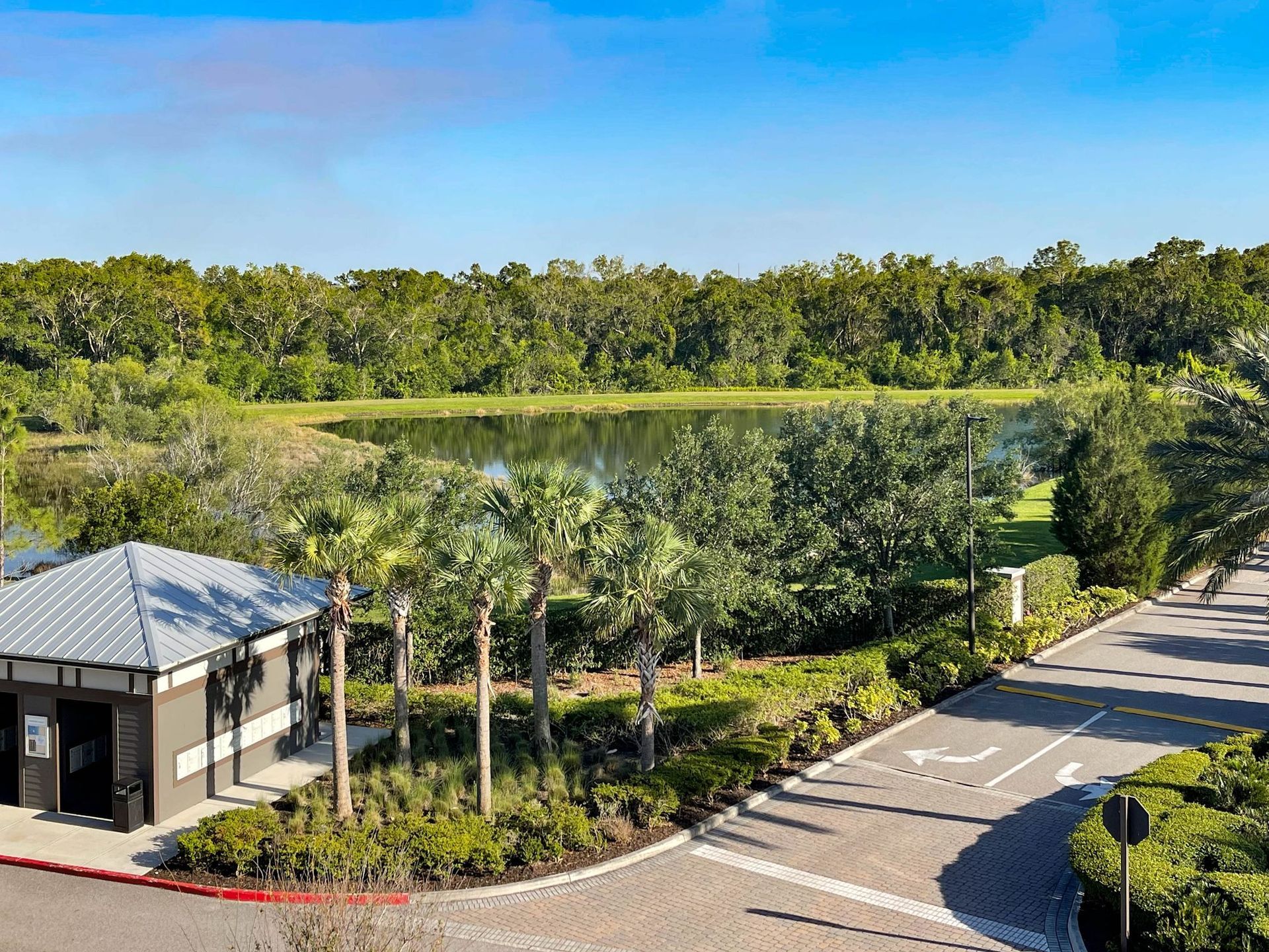 driveway to Creekside Ranch Apartments next to a pond