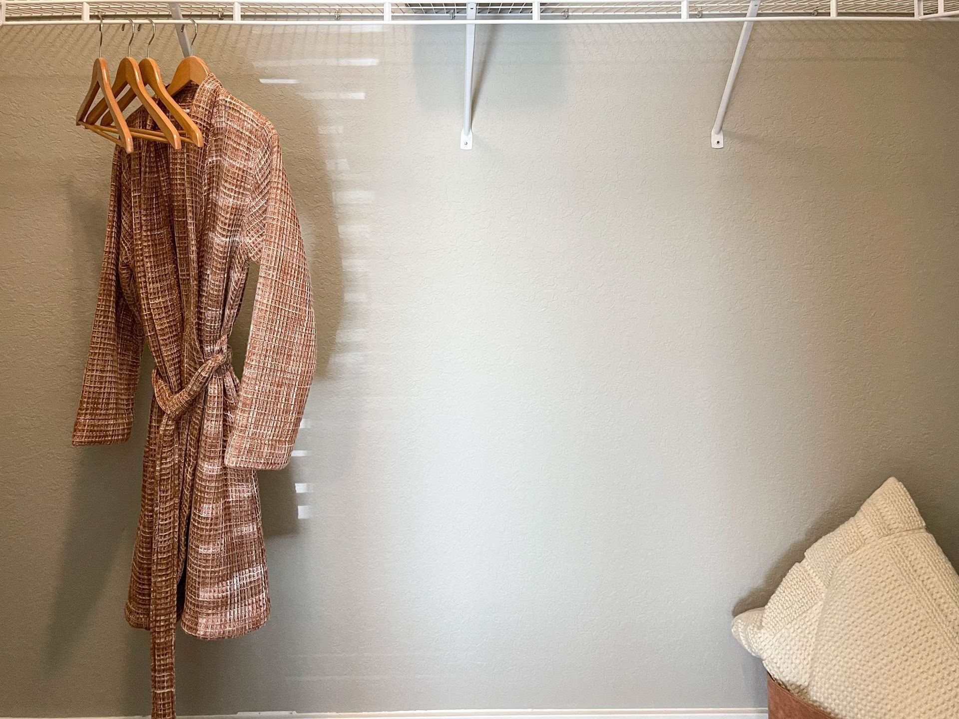 robe on a hanger in a spacious closet