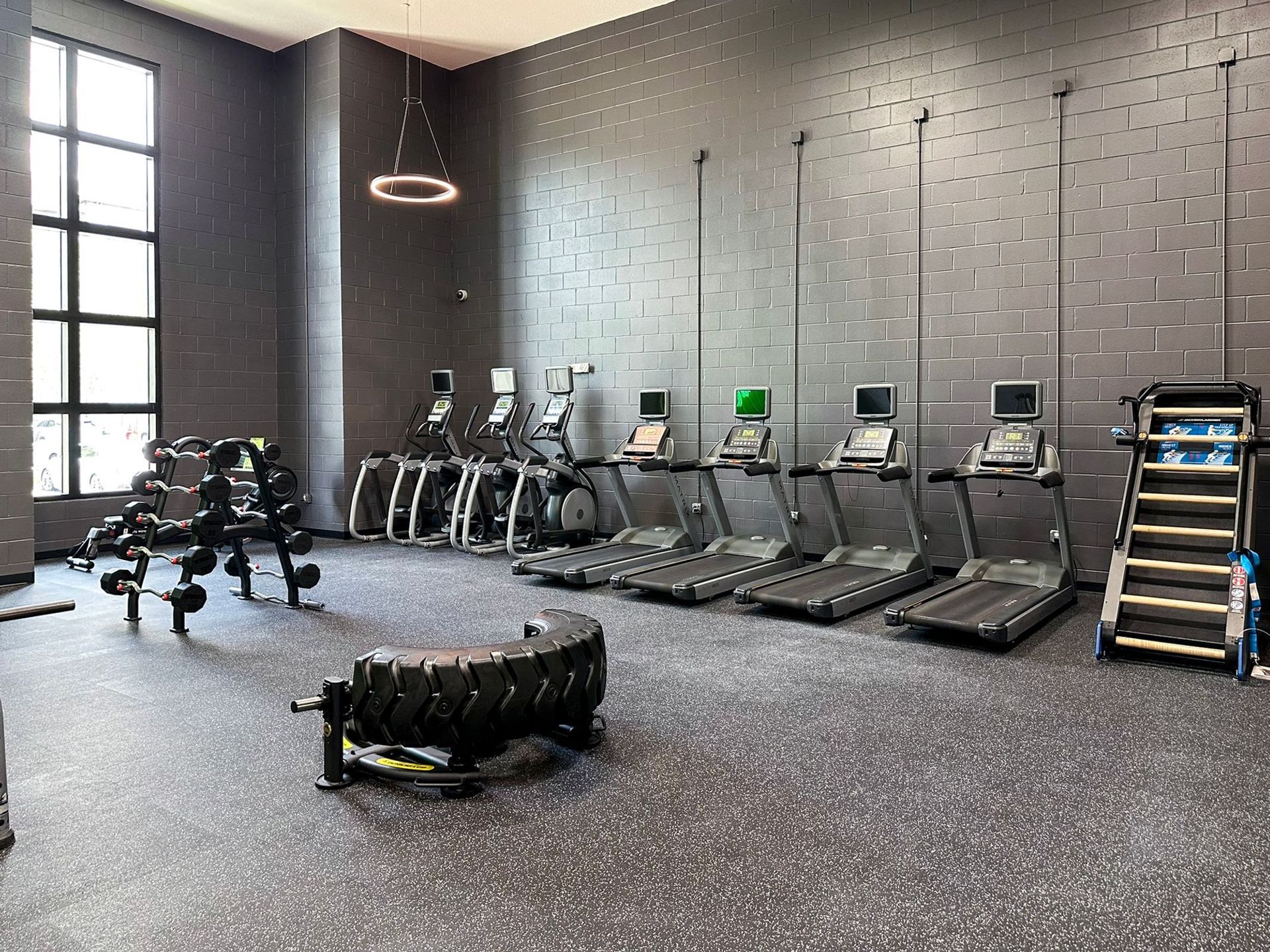 cardio machines and free weights in the Creekside Ranch Apartments on-site fitness center