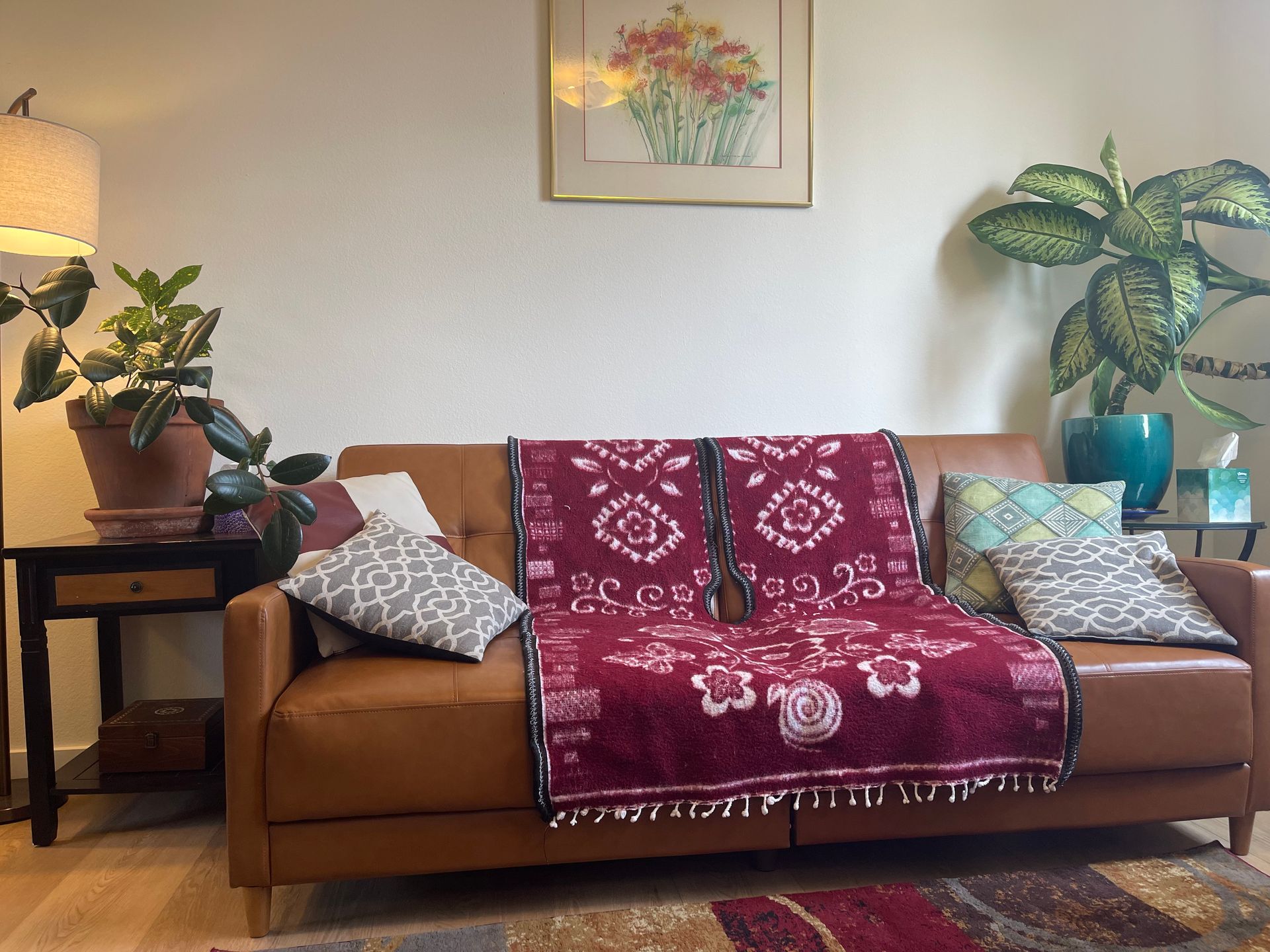 A man and a woman are hugging each other on a couch.