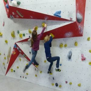 Kinder am klettern an einer Indoor-Kletterwand