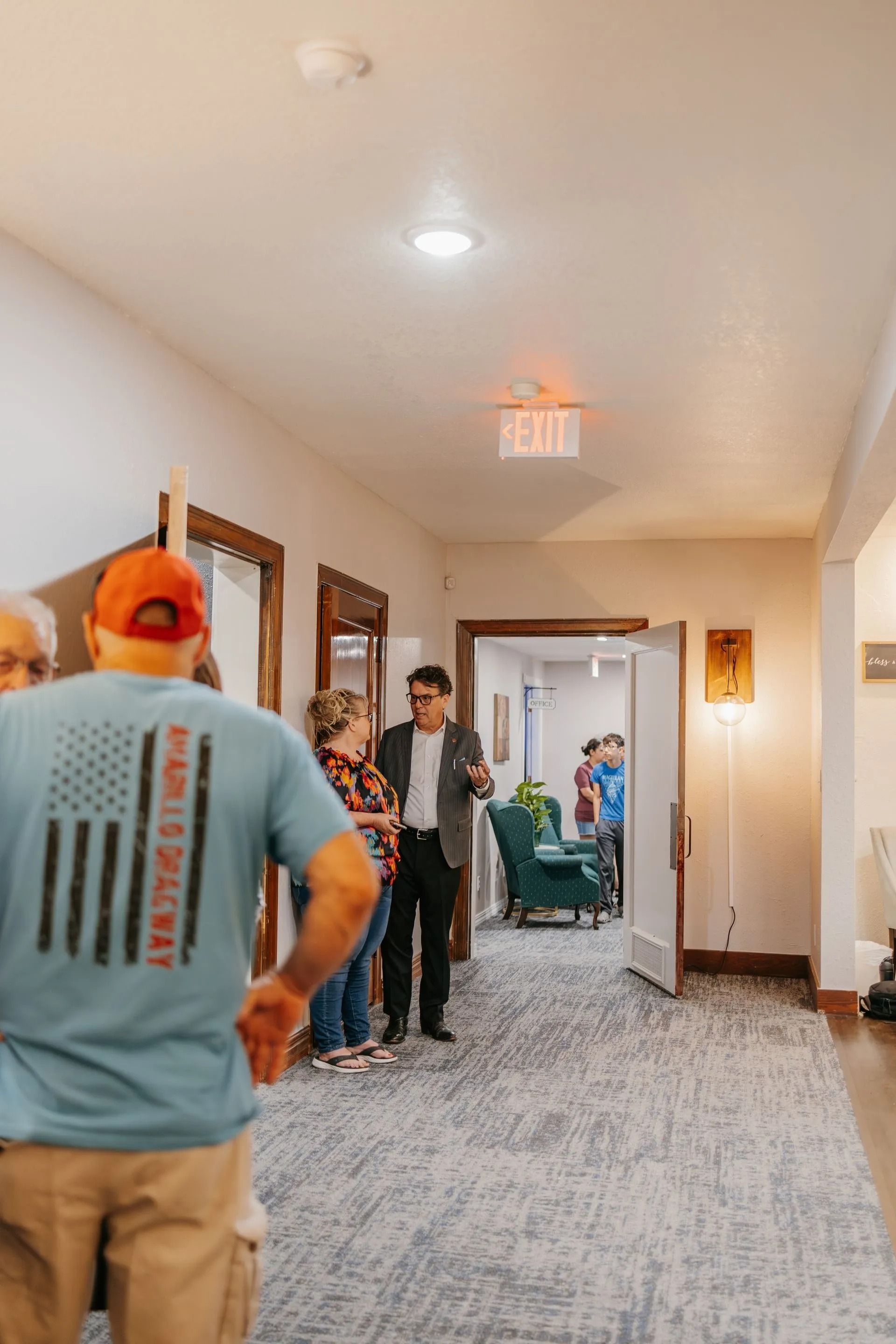 A group of people are standing in a hallway.