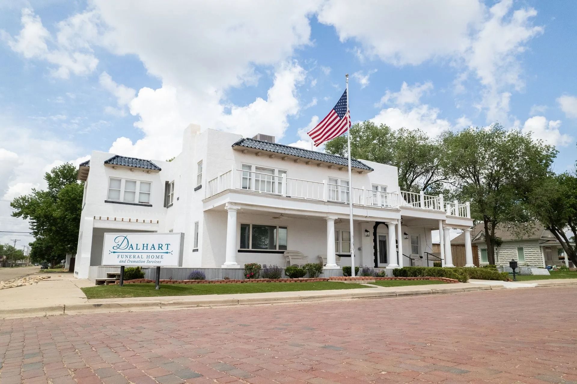 A white house with an american flag flying in front of it