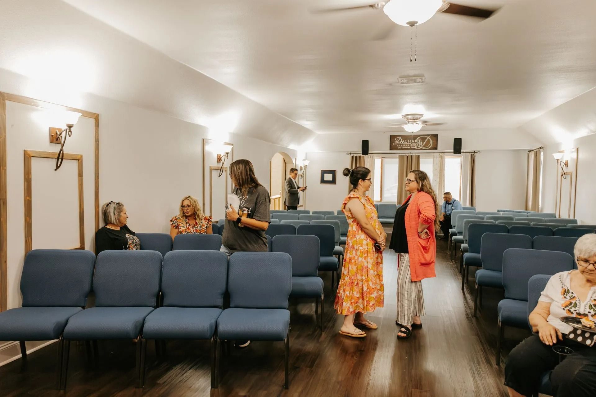 A group of people are standing and sitting in a church.