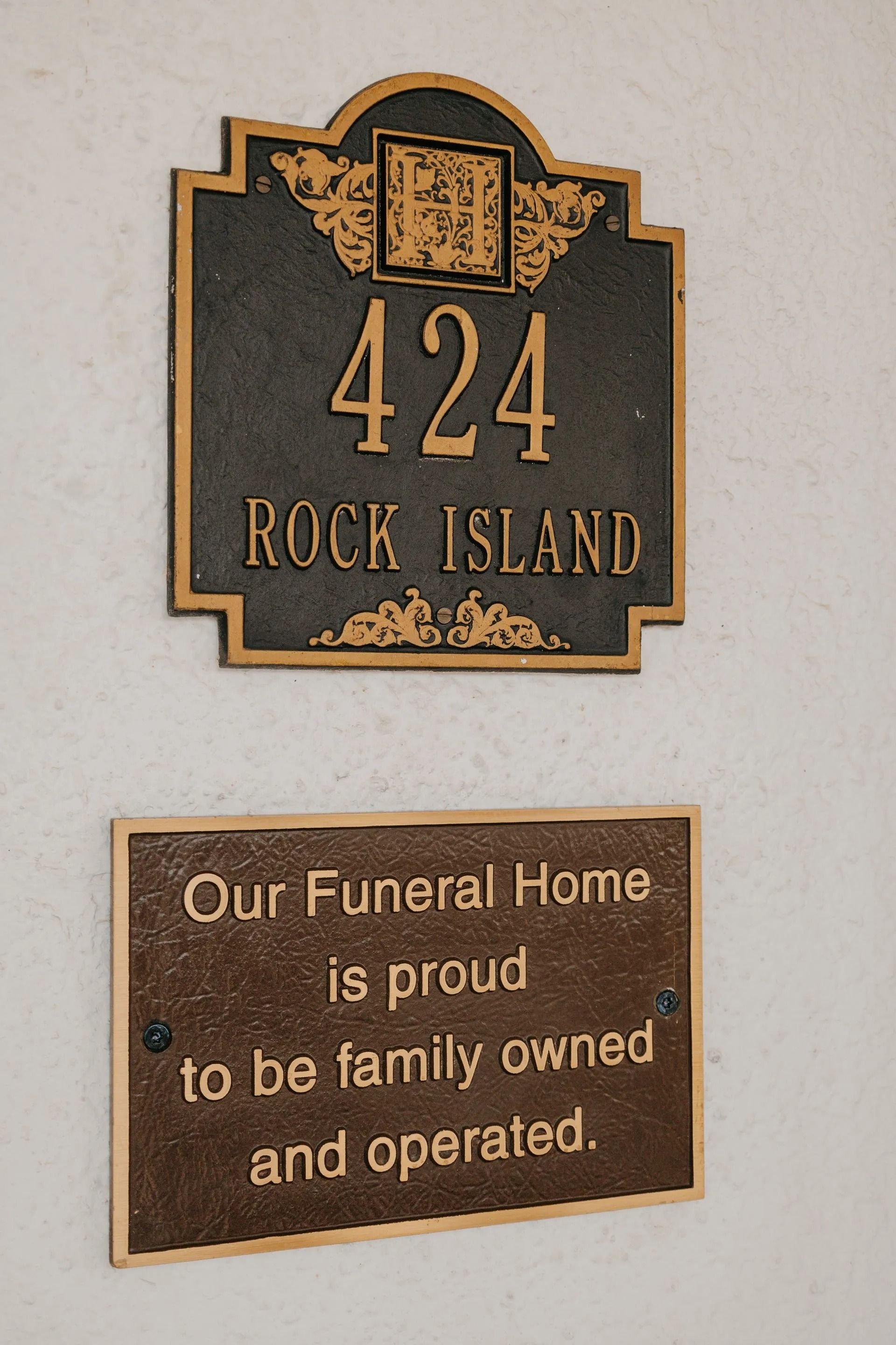 A plaque on a wall that says our funeral home is proud to be family owned and operated
