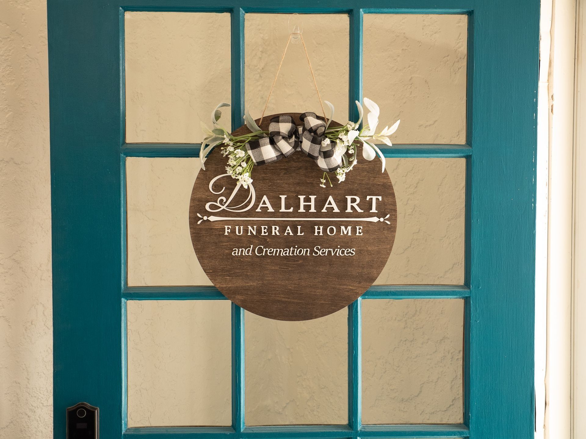 A blue door with a sign on it that says dalhart funeral home.