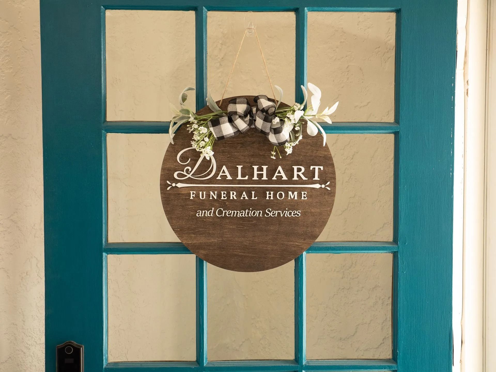 A blue door with a sign on it that says dalhart funeral home.