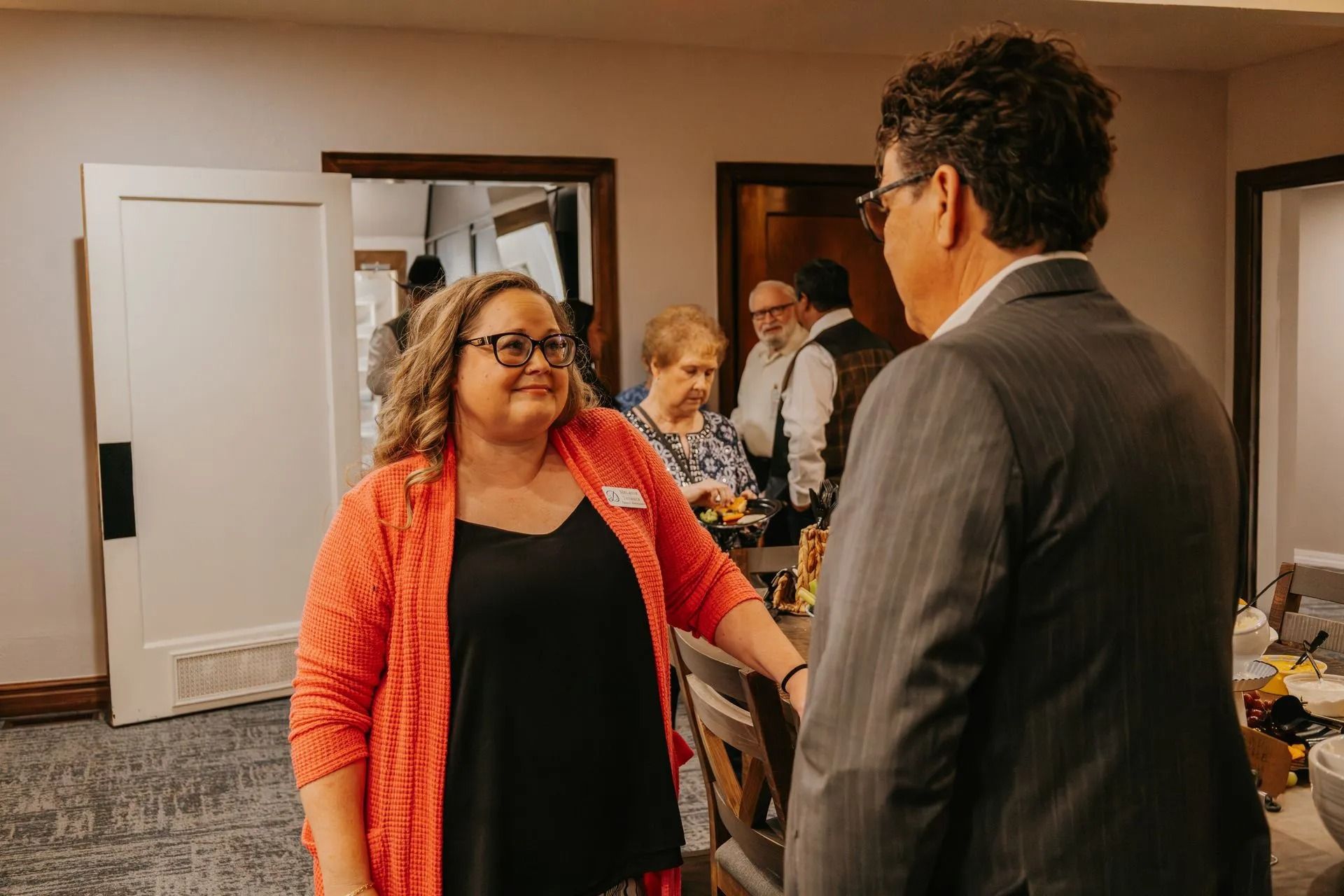 A man and a woman are talking to each other in a room.