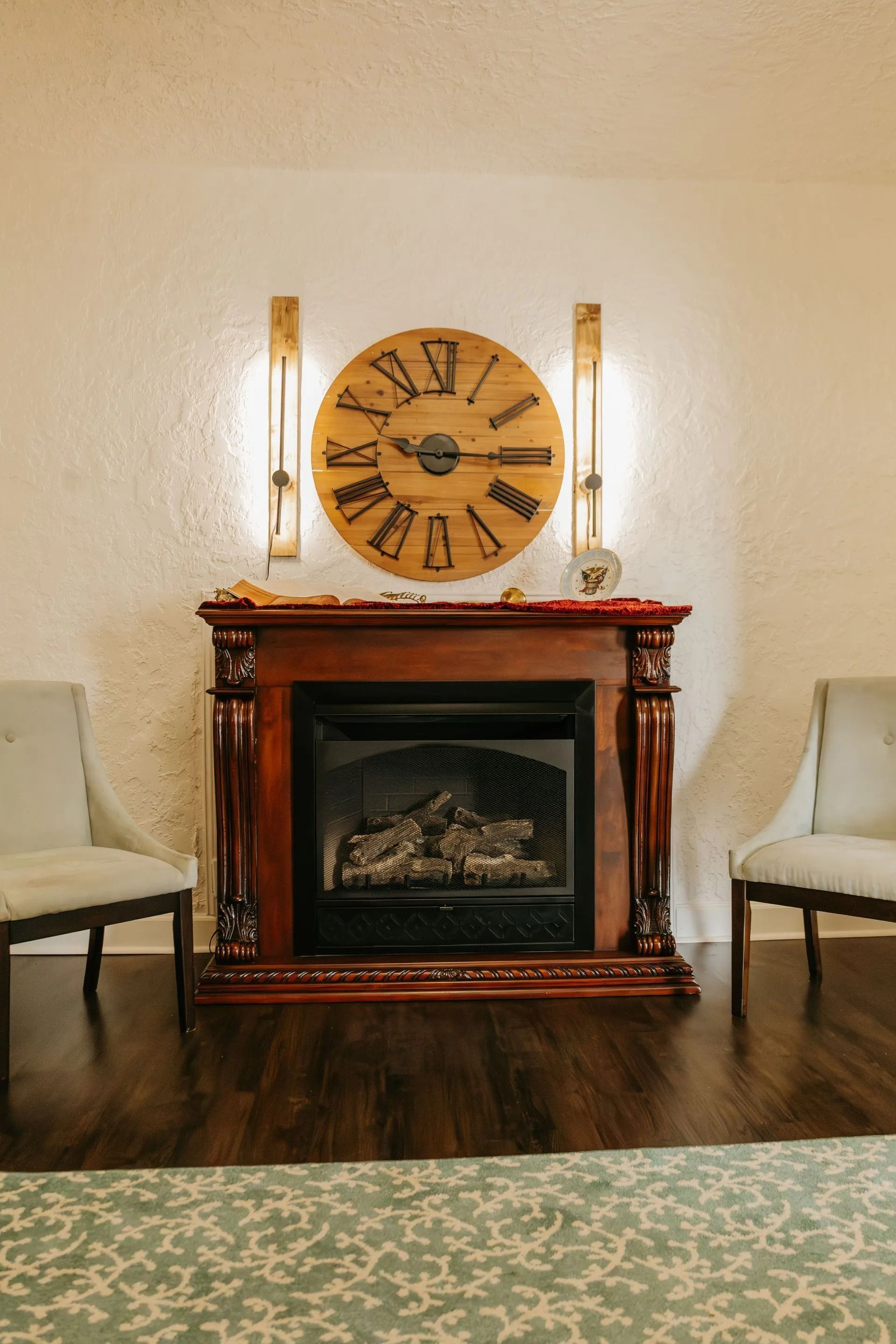 A living room with a fireplace and a clock on the wall.