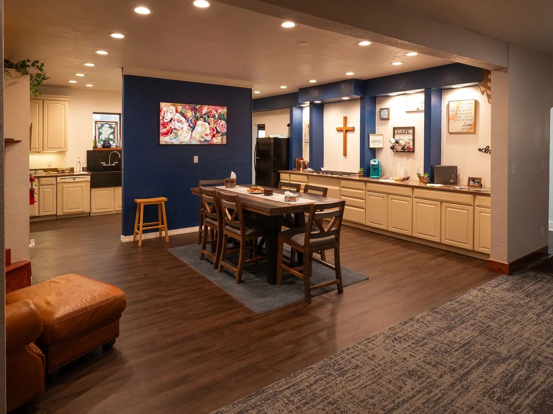 There is a table and chairs in the middle of the room.