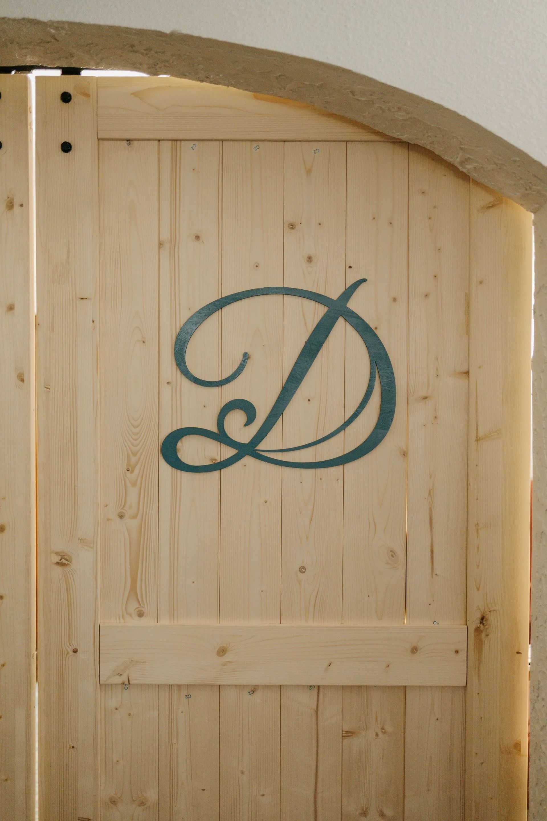 A wooden door with the letter d painted on it