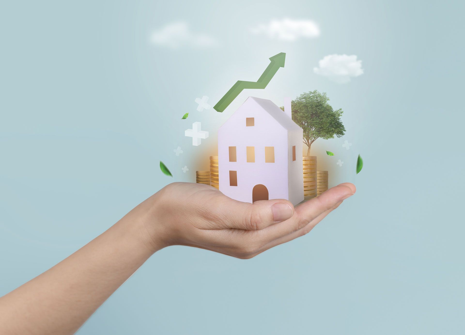 Hand holding a house with money, growing green arrow, tree, and clouds, symbolizing real estate growth.