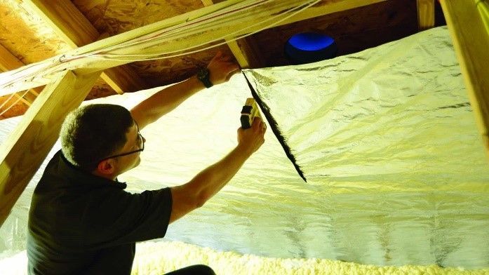 A Man Repairing a Broken Insulator