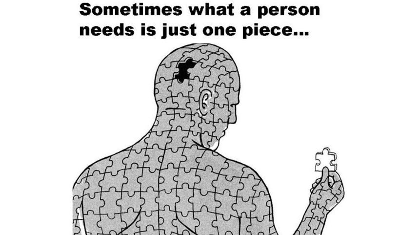 A man made out of puzzle pieces is holding a piece of puzzle.