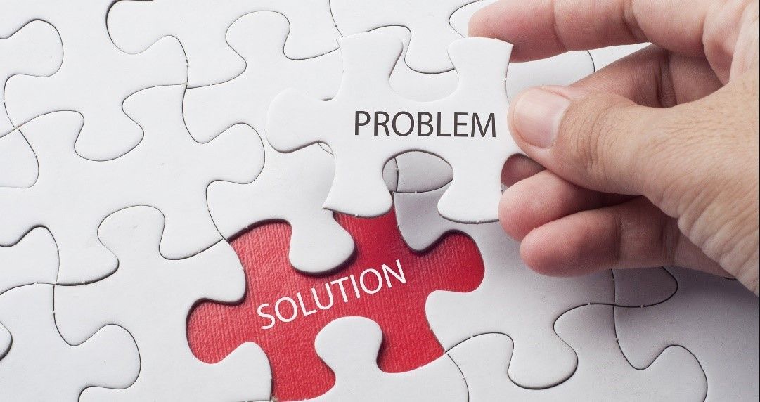 A man made out of puzzle pieces is holding a piece of puzzle.