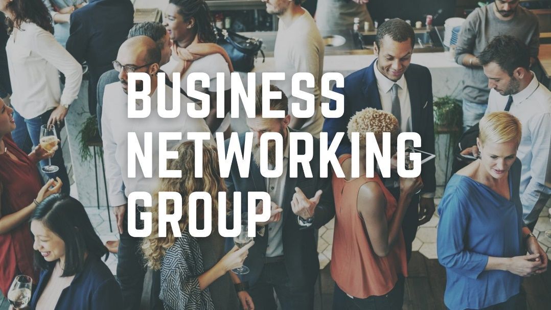 A group of people are standing in a room with the words `` business networking group '' written above them.