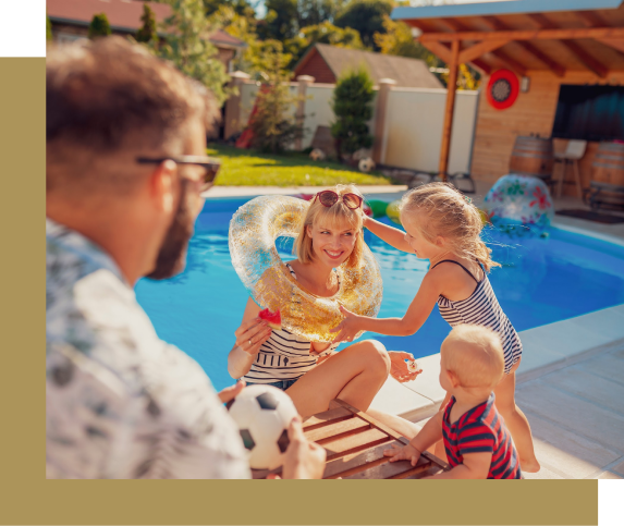 Family near a pool, mom with a swim ring, kids playing, sunny day.