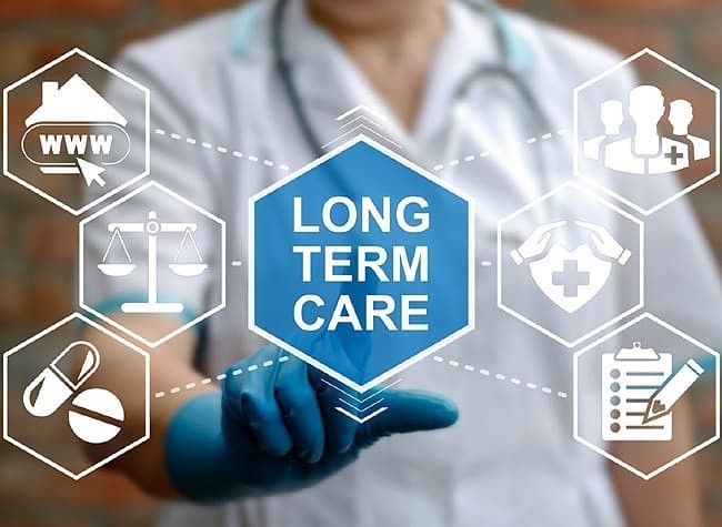 A doctor is pressing a button on a screen that says long term care.