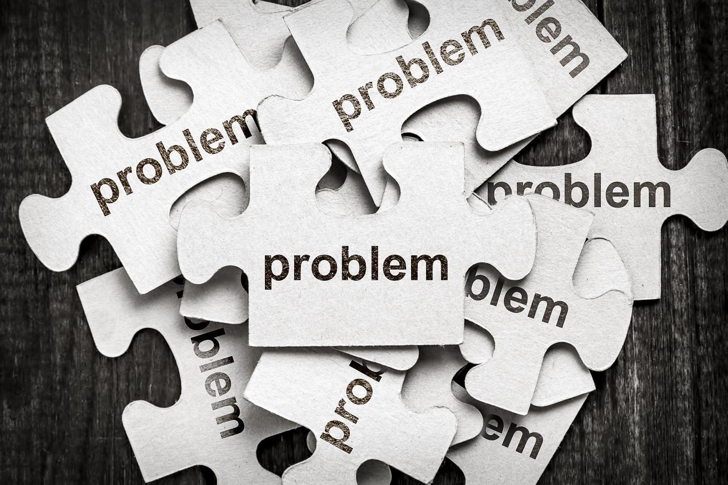 A pile of puzzle pieces with the word problem written on them