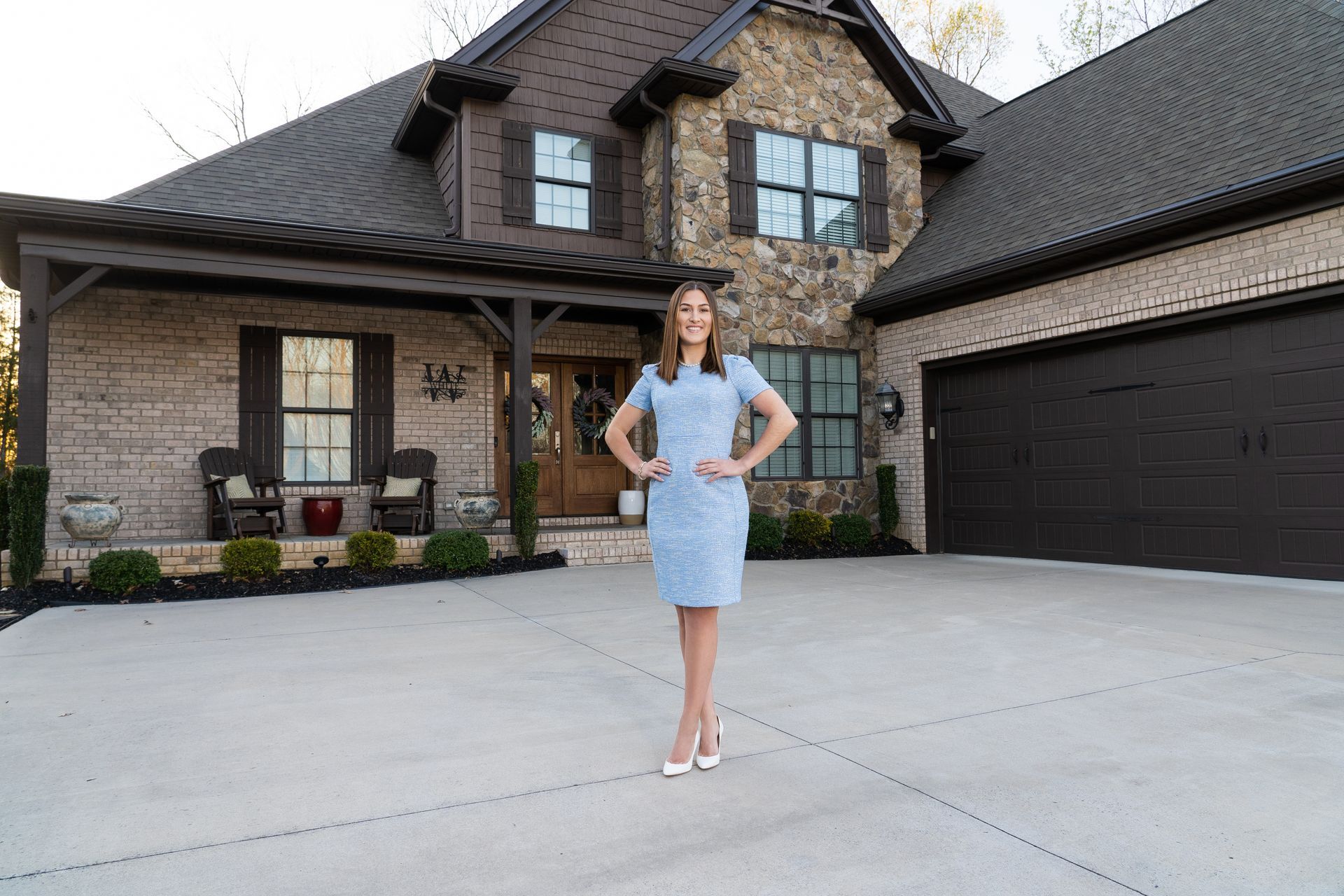 Hand handing keys to another hand. Woman in orange shirt.