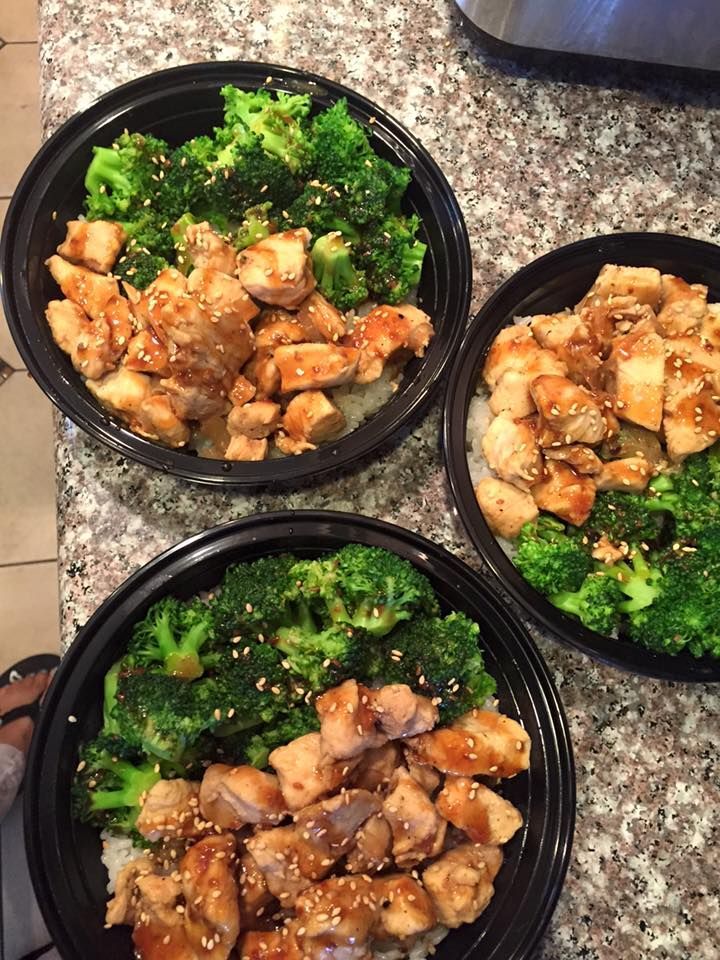 Three bowls of chicken and broccoli are on a counter.