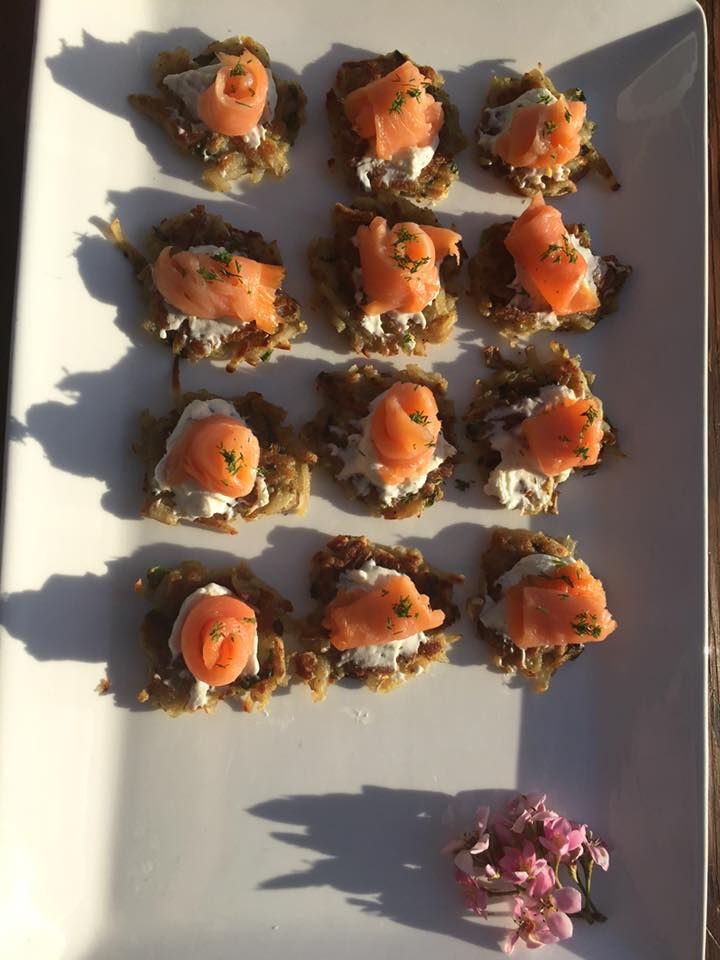 A white plate topped with smoked salmon appetizers