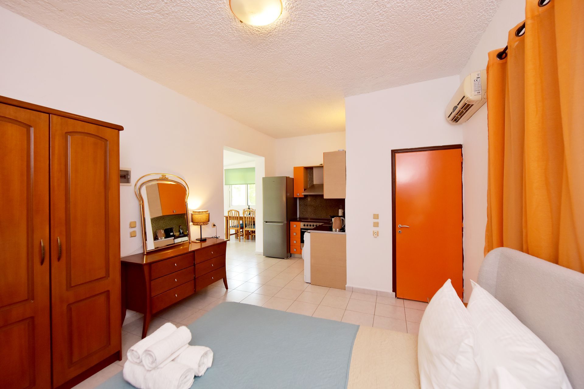 A hotel room with a bed and a dresser