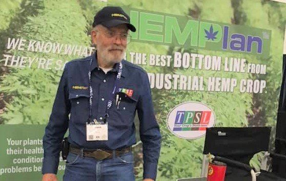 A man is standing in front of a sign that says hemp plan