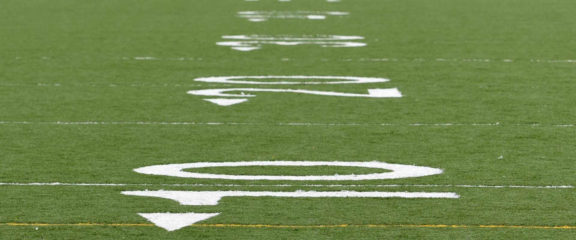 A close up of a football field with white lines on it.