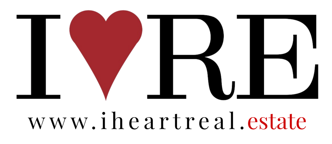 A logo for i heart real estate with a red heart