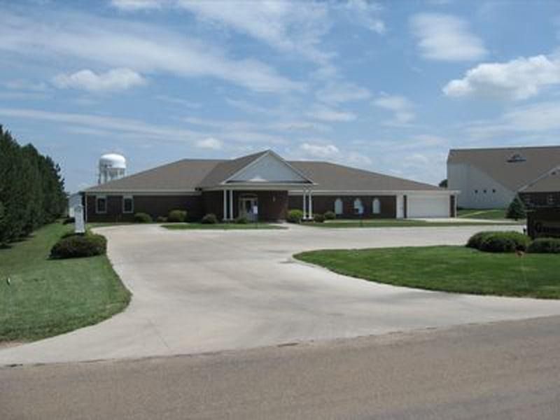 A large house with a water tower in the background