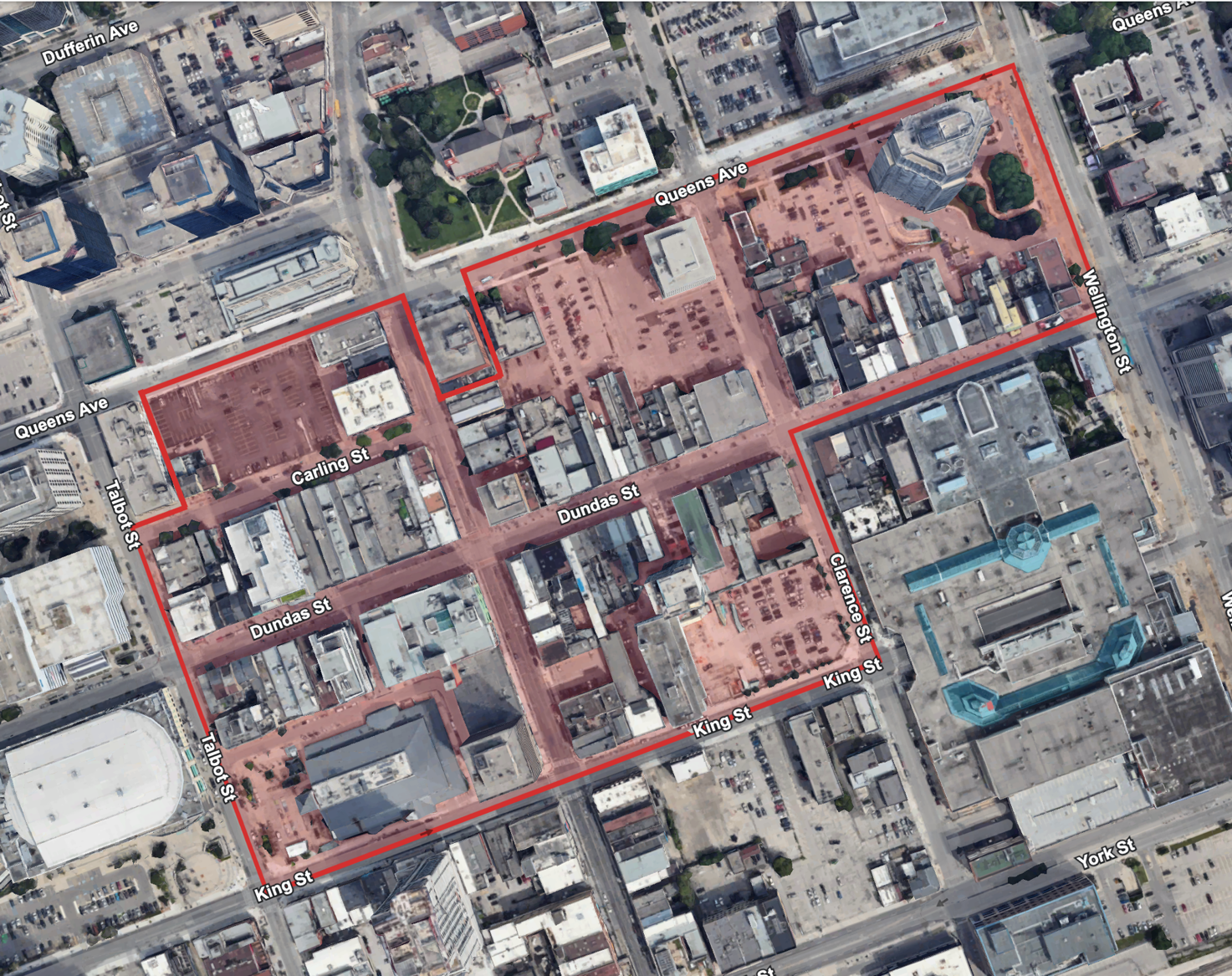 An aerial view of a city with a red outline around the buildings.