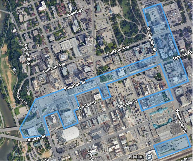 An aerial view of a city with a red outline around the buildings.