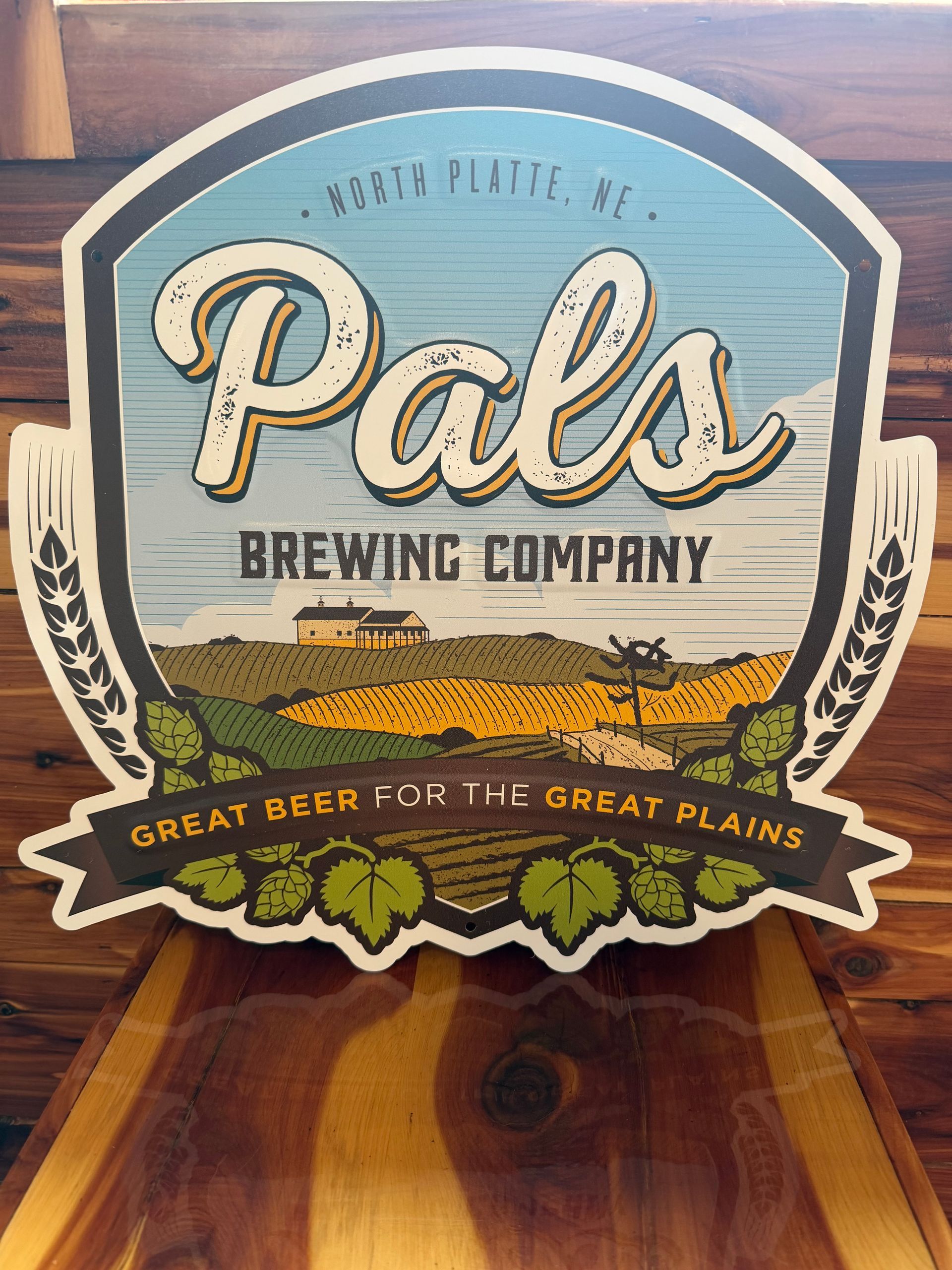 Sign for Pals Brewing Company, North Platte, Nebraska, with a landscape scene and the text 