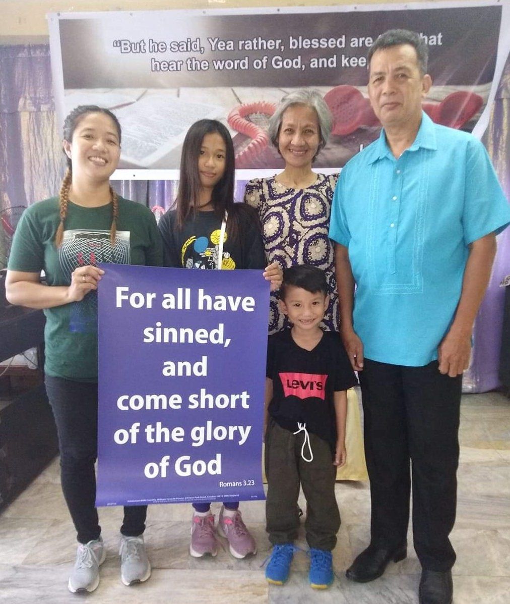 A group of people holding a sign that says for all have sinned and come short of the glory of god