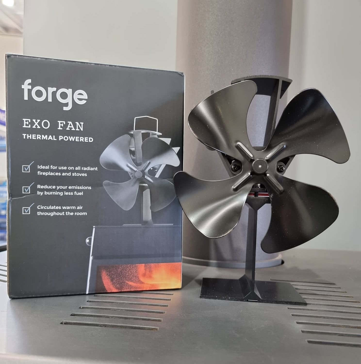 A fan is sitting next to a box that says forge