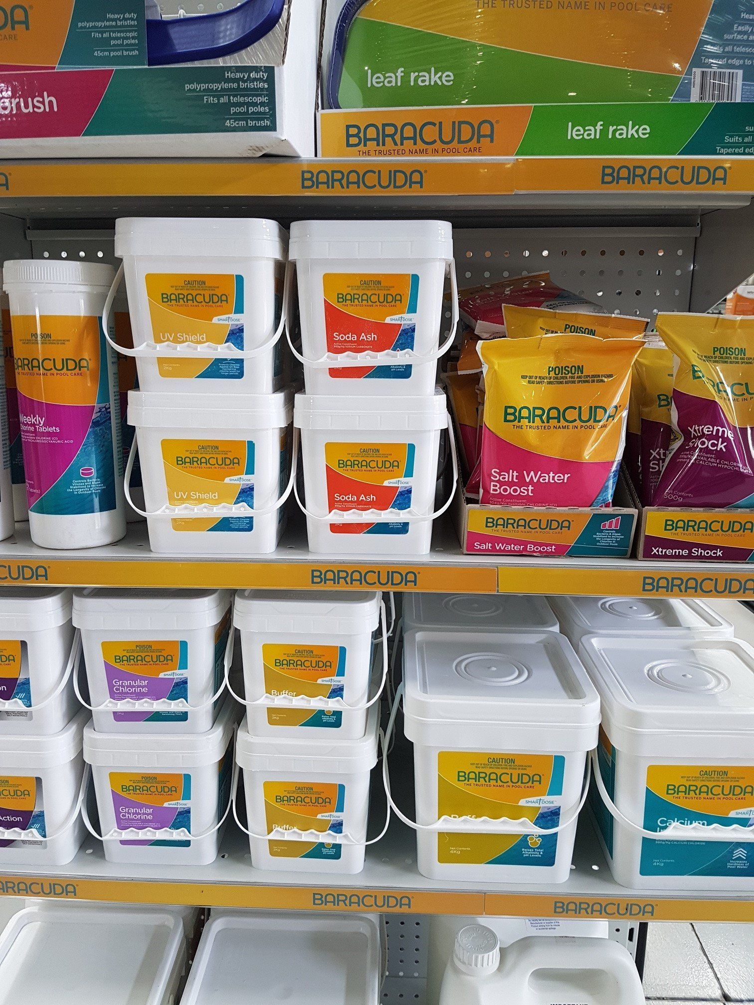 A store shelf filled with buckets and bags of chemicals.