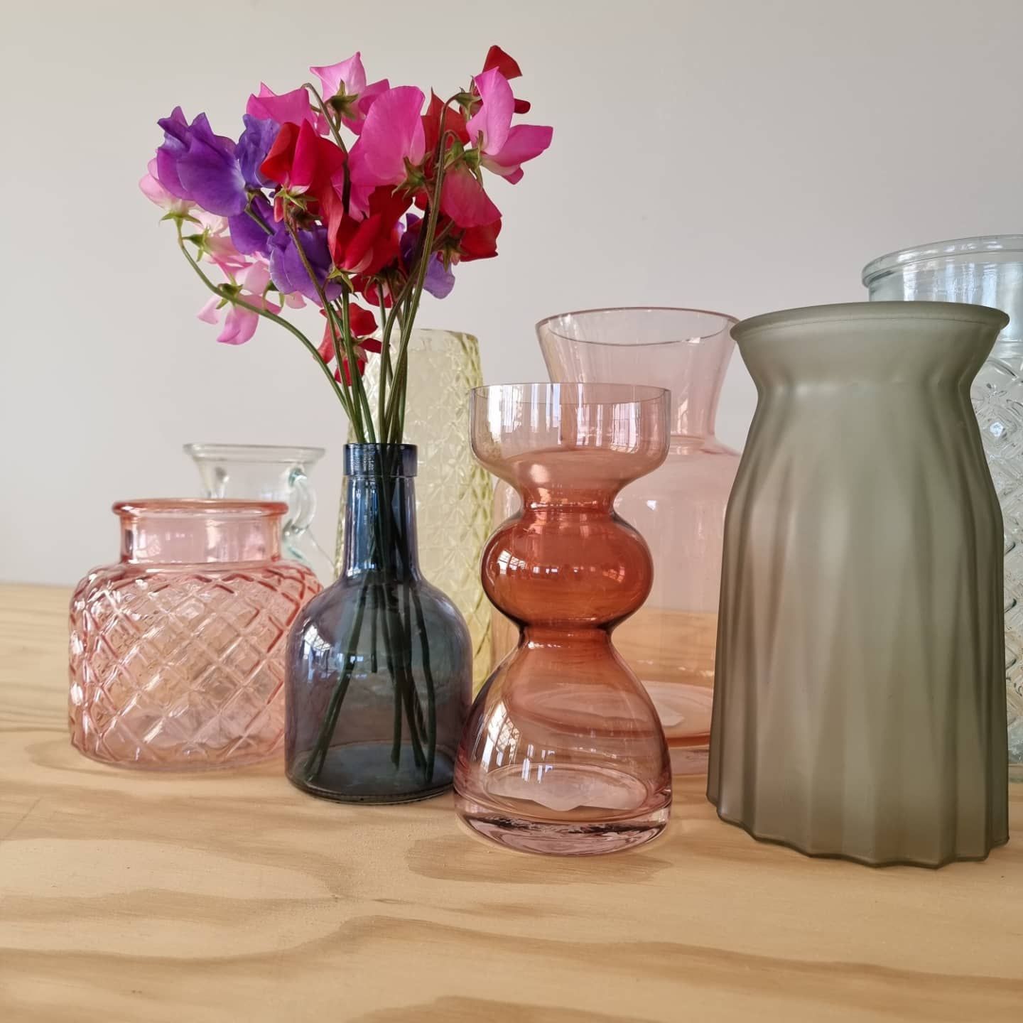A bunch of vases with flowers in them on a table