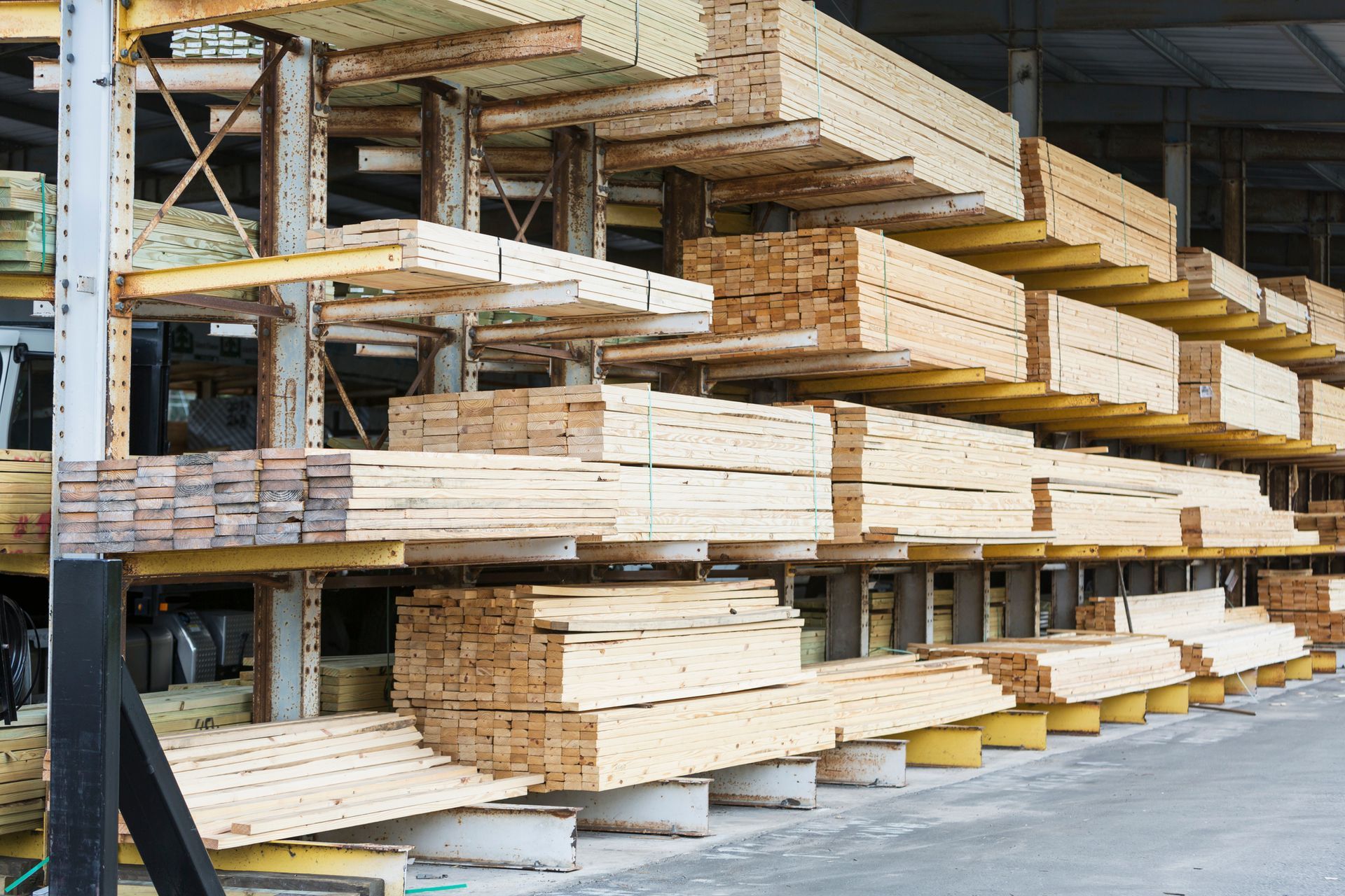 A warehouse filled with lots of wooden boards on shelves.