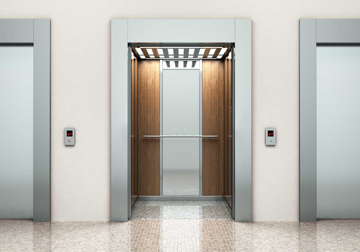 Elevator with open doors, wooden interior, flanked by closed elevator doors on a white wall.