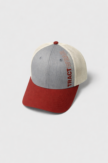 A grey and cream mesh-back trucker hat featuring a red visor and the word 