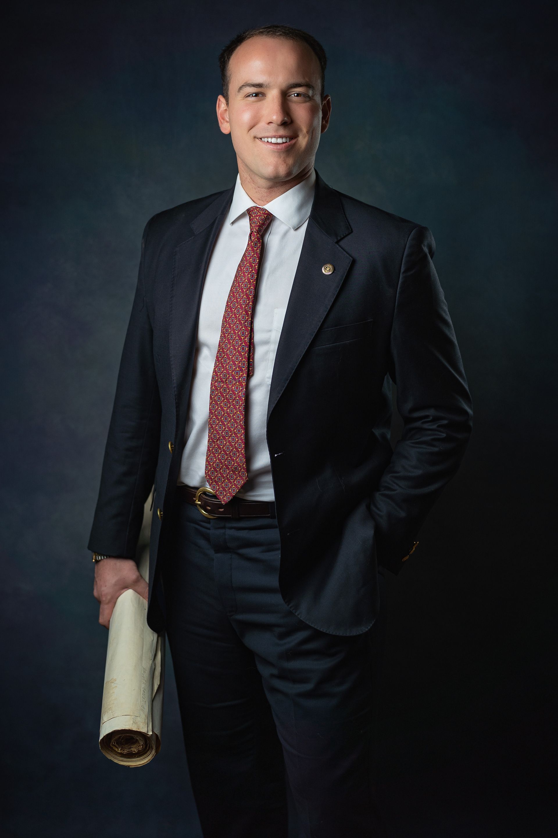 Ross Latham Boggess holding blueprints in Atlanta Georgia, Principal Broker of Carto Commercial headquartered in Lexington Kentucky.